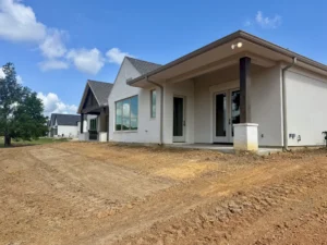 Jeff Paul custom home site before landscaping rear view